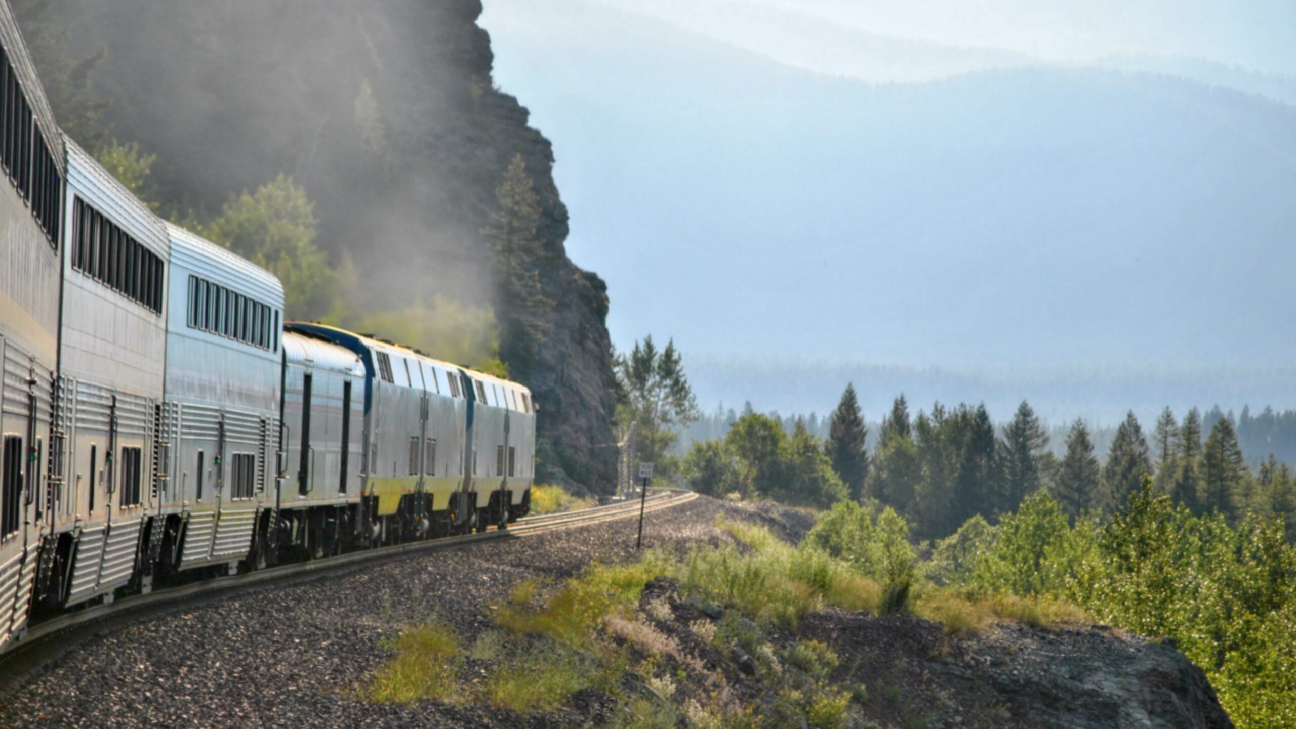 Amtrak's Empire Builder train rounds a curve in the Rockies, approaching West Glacier Montana.